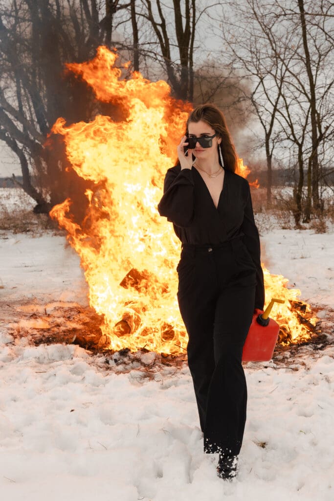 Creative fire photography portrait session with female model in winter snow in Wisconsin