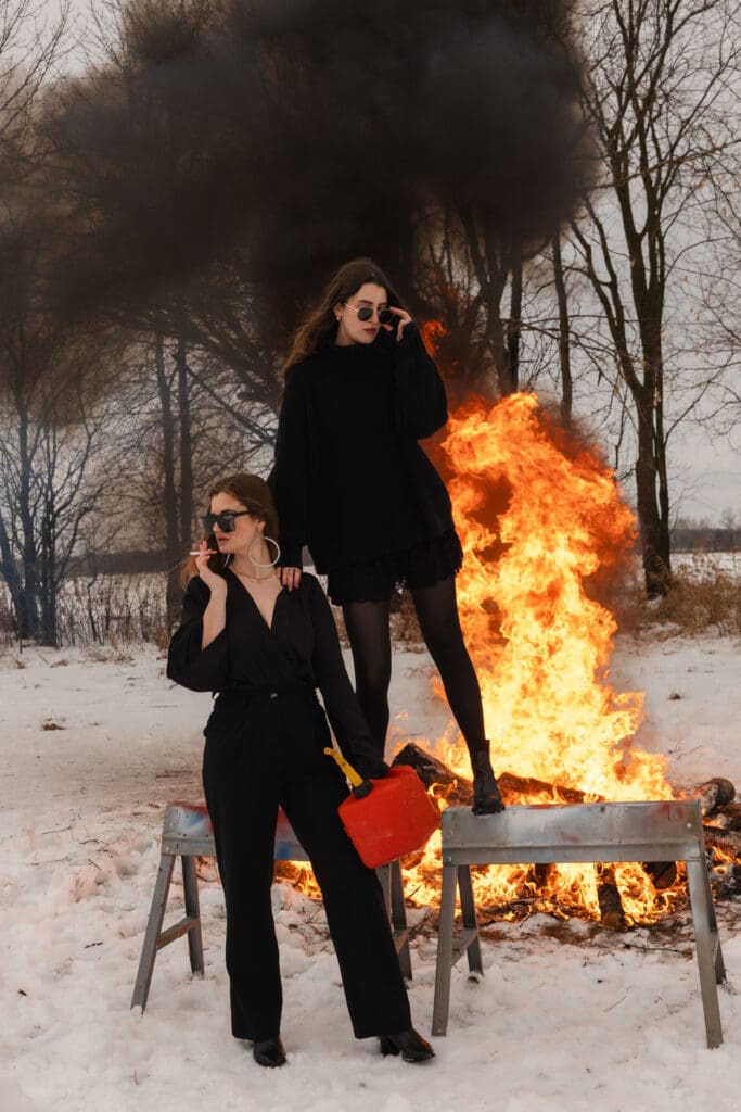 Creative fire photography portrait session with female model in winter snow in Wisconsin