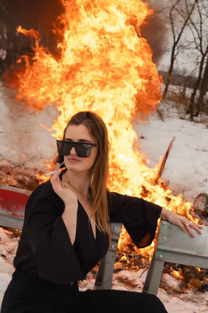 Creative fire photography portrait session with female model in winter snow in Wisconsin