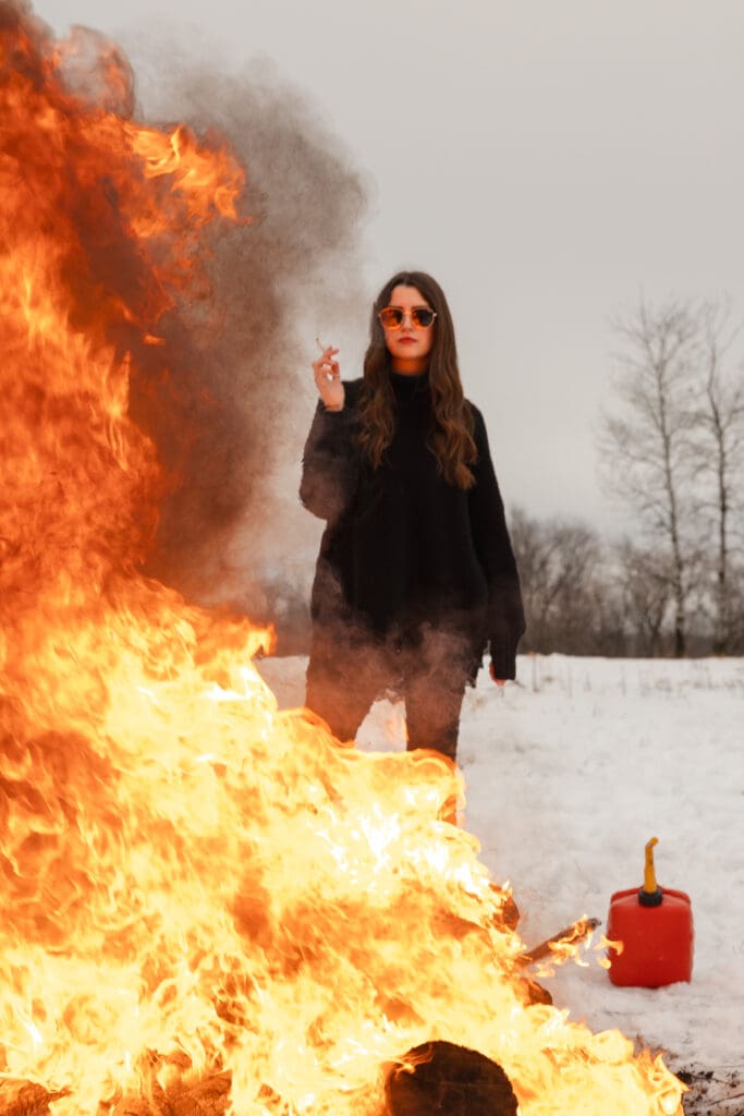 Creative fire photography portrait session with female model in winter snow in Wisconsin