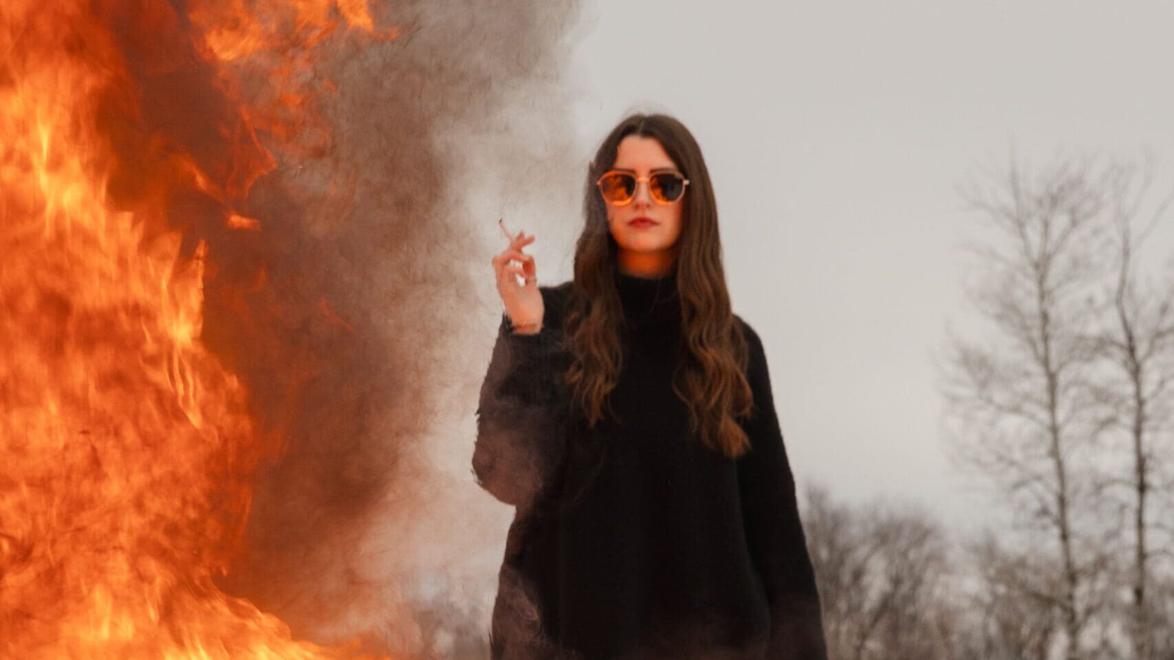 Creative fire photography portrait session with female model in winter snow in Wisconsin