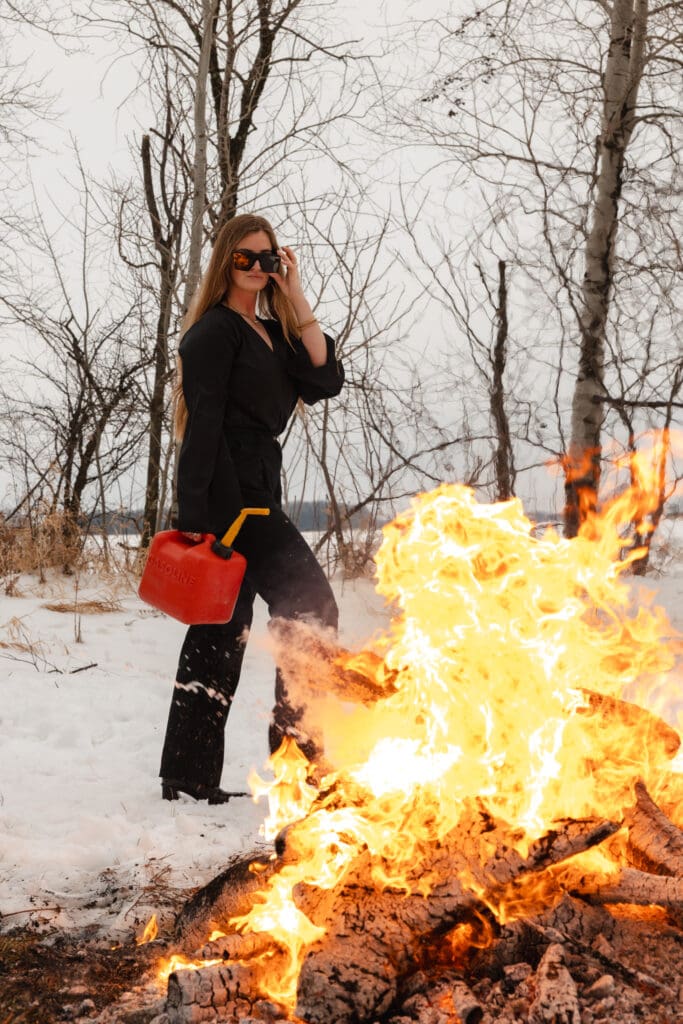 Creative fire photography portrait session with female model in winter snow in Wisconsin