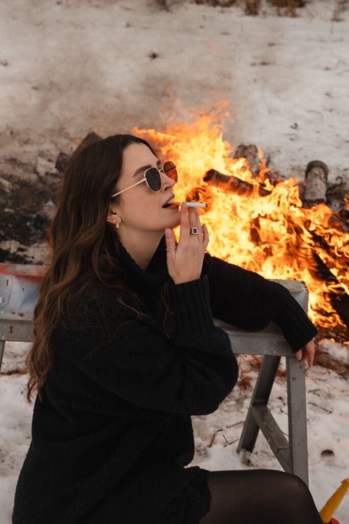 Creative fire photography portrait session with female model in winter snow in Wisconsin