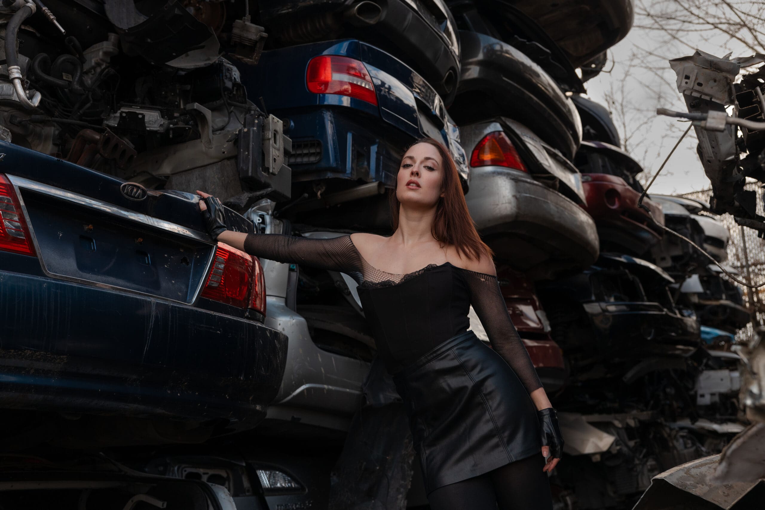 Model climbing on abandoned bus roof during unique location photoshoot in Nashville